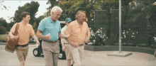 a group of older men are walking down a street