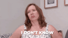 a woman sitting on a couch with the words i don 't know behind her