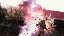 a statue of a monster is being destroyed by a large explosion