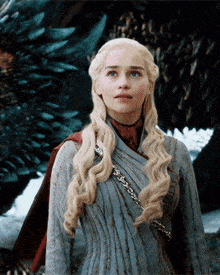 a woman with long blonde hair is standing next to a dragon