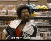 a man in a mcm jacket is sitting in front of a candy aisle in a store .