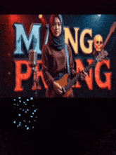 a woman singing into a microphone while holding a guitar in front of the word mang hang