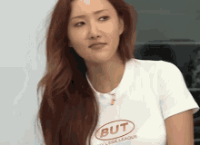 a woman wearing a but college league t-shirt