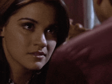 a close up of a woman looking at a man 's face