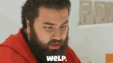 a man with a beard is wearing a red hoodie and says weip .