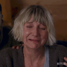 a close up of a woman 's face with netflix written on the bottom