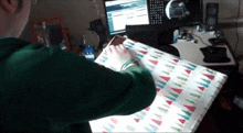 a person wrapping a gift with a christmas theme