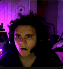 a man wearing headphones is looking at the camera
