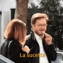 a man and a woman are standing next to each other with the words la sucette written on the bottom