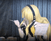 a girl with long blonde hair wearing headphones is reading a newspaper