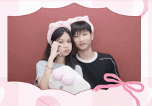 a boy and a girl are posing for a picture with a hello kitty pillow