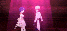 a man and a woman are standing next to each other on a stage in a pink light .