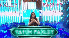 a woman is standing in front of a sign that says tatum paxley on it .