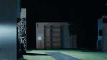 a person walking in a dark room with a phone that says ' pro ' on it
