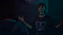 a woman wearing a blue shirt that says " i love you " on it