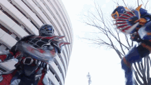 two robots are fighting each other in front of a tall building