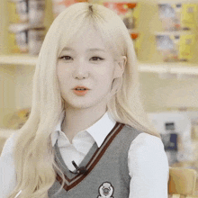a girl with blonde hair is wearing a vest with a badge that says cd