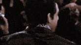 a close up of a man 's back with a graffiti drawing on his neck that says ' one '
