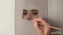 a person is painting a woman 's face with a brush made in animotica