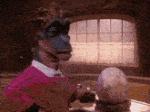 a dinosaur in a pink shirt is standing next to a large egg