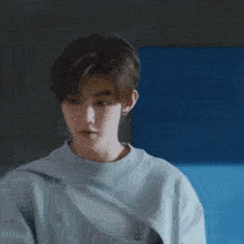 a young man in a grey nike sweatshirt is reaching out his hands