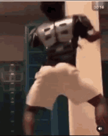 a man in a superhero costume is dancing in a gym .