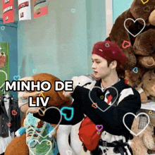 a man in a red beret is holding a stuffed animal with the words minho de liv above him