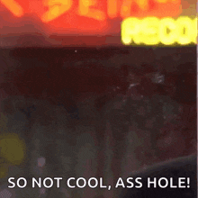 a close up of a man with the words so not cool ass hole