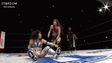 two women in a wrestling ring with the word stardom on the bottom