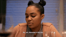 a woman says " so um saturday 's the day " at a table