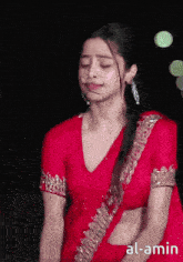 a woman in a red saree with the word al-amin on the bottom