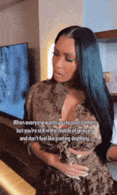 a woman with long black hair is standing in front of a television with a caption that says when everyone wants you to post