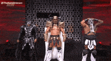 a group of wrestlers are standing in front of a wall that says aew