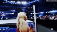 a woman in a wrestling ring with the word usa on the bottom left