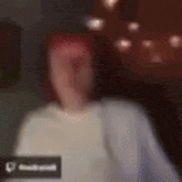 a blurry picture of a person 's face with a heart icon in the corner .