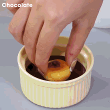 a person is dipping a piece of food into chocolate