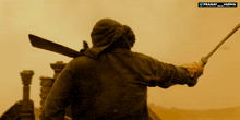 a man holding a sword in front of a banner that says pranay varma
