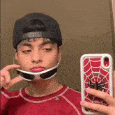 a young man wearing sunglasses and a hat is taking a selfie