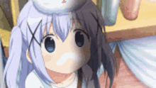 a girl with a bunny hat on her head is looking at the camera .
