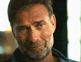a close up of a man 's face with the words emily on the bottom right
