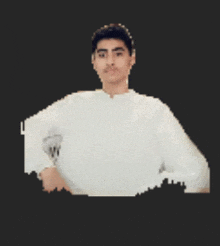 a young man wearing a white shirt and a watch looks at the camera