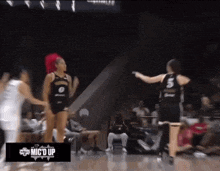 a basketball player with the number 5 on her jersey is pointing