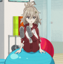 a girl is sitting on a blue ball with her feet up