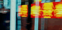 a painting of a man 's face is behind a glass