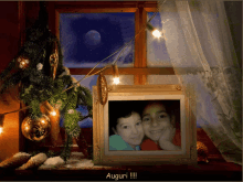 a picture of two children in front of a christmas tree with the word auguri on the bottom