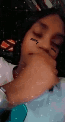 a woman with a tattoo on her face that says merry on it
