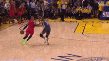 a basketball player with the number 10 on his back is dribbling the ball