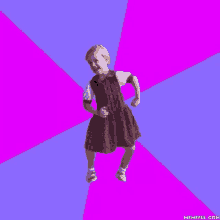 a little girl in a plaid dress is dancing on a blue and purple background