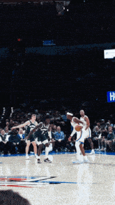a basketball game is being played in front of a crowd that says toyota on the wall