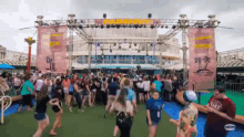 a large group of people are dancing in front of a stage that says paradise